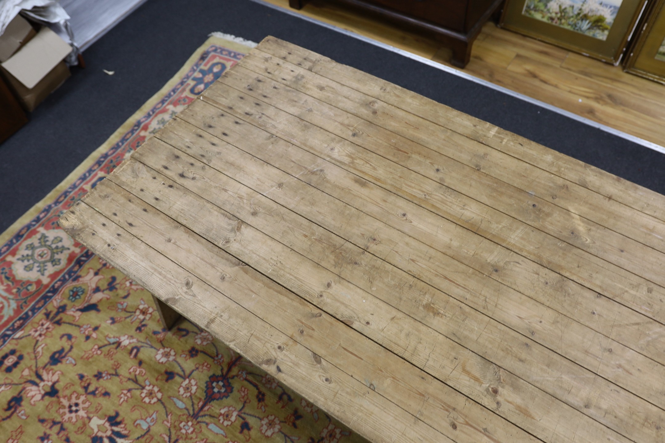 A large French rectangular pine and wrought iron folding trestle table, length 300cm, depth 91cm, height 74cm